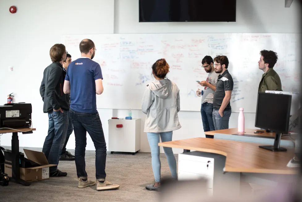 Ahrefs team collaborating in their office